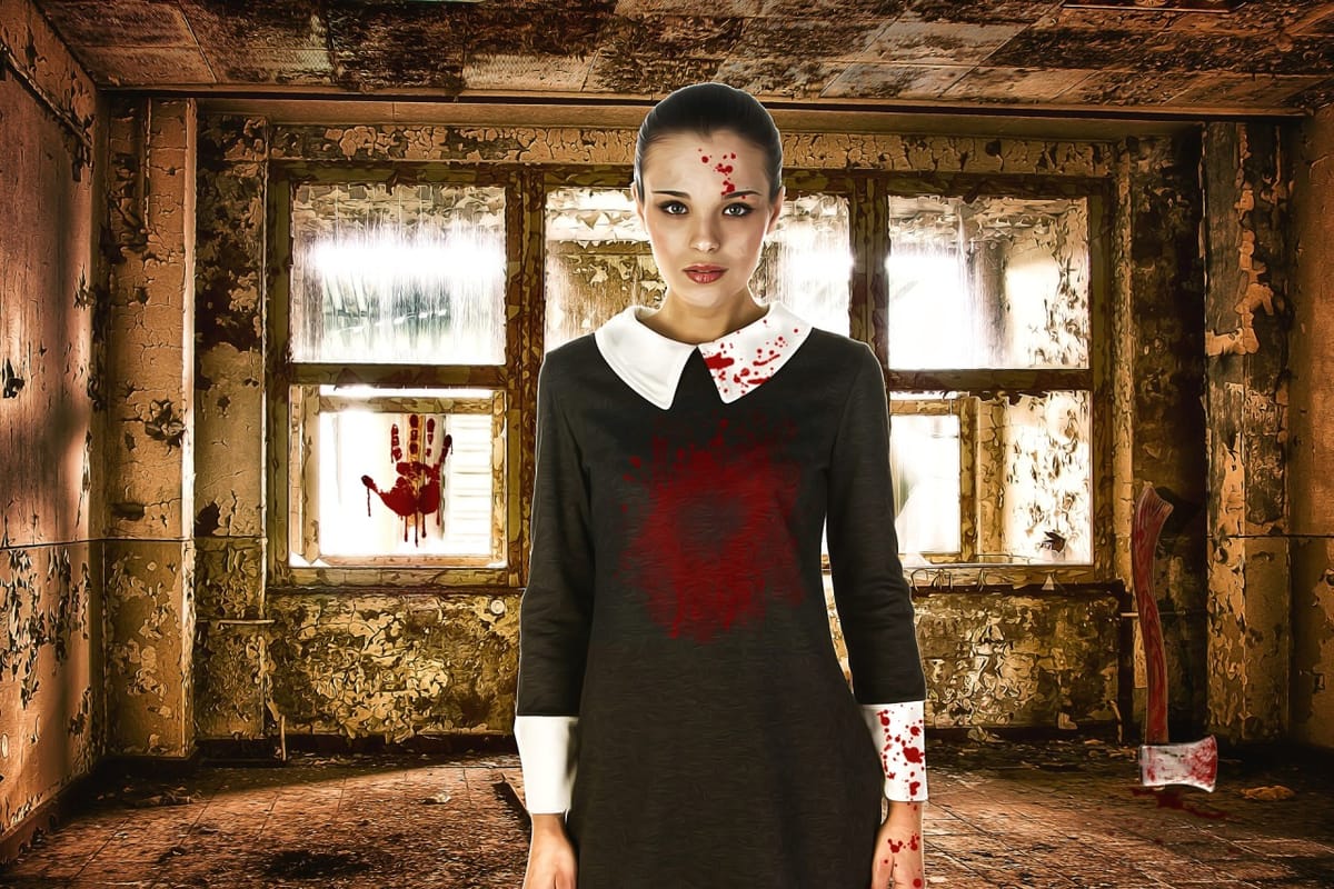 A woman with blood on her in a room with a bloody ax in the corner. 